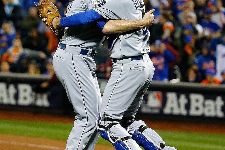 Wade Davis (left) and Drew Butera of the Kansas City Royals finally can celebrate, banishing the nightmare of a seven-game loss to San Francisco in last year's World Series.