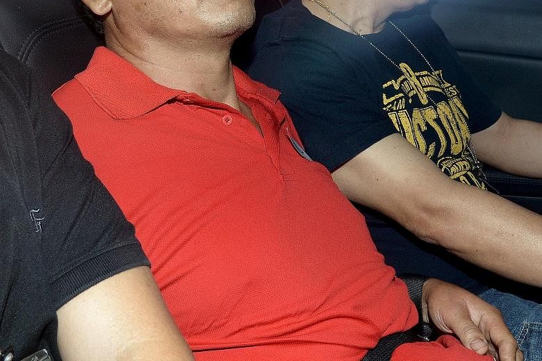 Chinese national Hu Ziqing (in red) was jailed 10 years yesterday after he pleaded guilty to a charge of culpable homicide for strangling his wife on Aug 8, 2013.