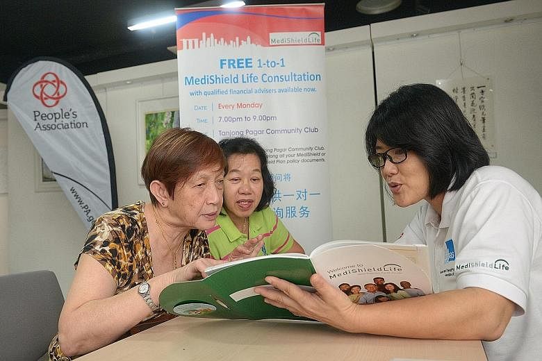 (From left) Madam Nancy Wong and retiree Rita Chow, 62, having a MediShield Life consultation with Ifpas volunteer Brenda Lim at Tanjong Pagar CC yesterday.