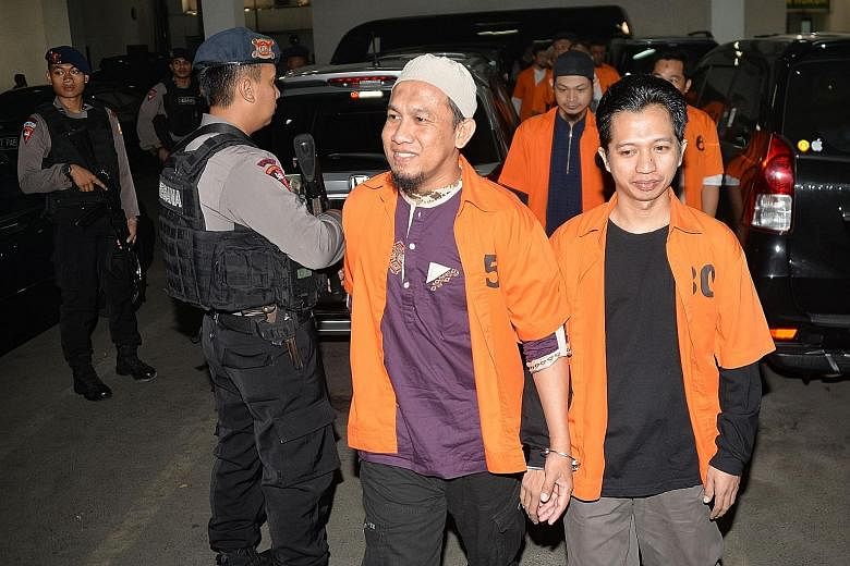Indonesian terror suspects arriving at a West Jakarta court for their trial last month. Over 165,000 people are locked up in Indonesia's prisons. More than 250 of them are convicted of charges related to terrorism and are housed in 44 prisons across 