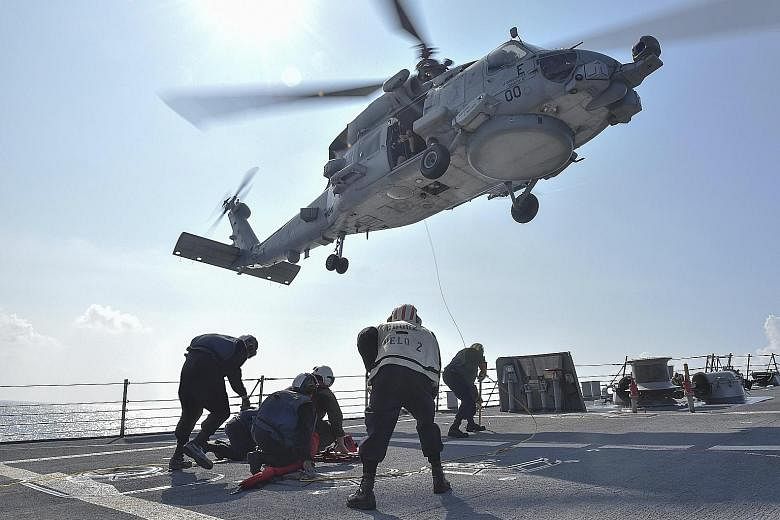 A medical training exercise on the deck of the USS Lassen in the South China Sea last Wednesday. Washington made its most significant challenge yet to China's claims last week by sending the guided-missile destroyer through territorial limits China a