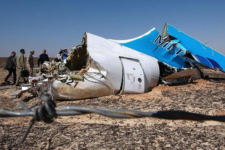 Officials examining the wreckage of the Russian Airbus plane at the site of the crash in Sinai, Egypt, on Sunday. The 18-year-old plane had previously been flown by a string of other airlines.