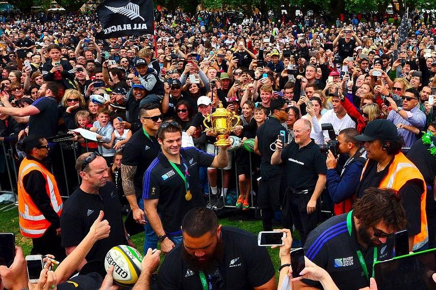 All Blacks captain Richie McCaw holding the Webb Ellis Cup during a victory parade at Victoria Park.