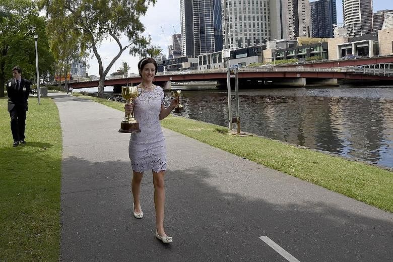 Australian Michelle Payne with the Melbourne Cup trophy yesterday, a day after she became the first female jockey to win the 154-year-old "race that stops a nation" when she rode outsider Prince of Penzance at Flemington. Despite this success, women 