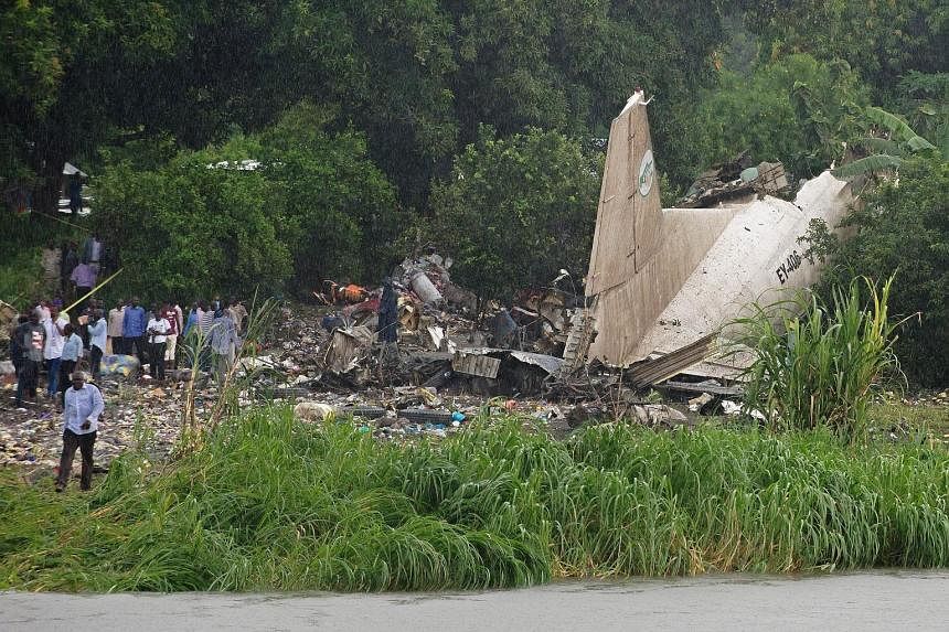 The wreckage of the Russian-built Antonov plane, which crashed in a small farming community on the banks of the White Nile River, close to Juba airport in South Sudan's capital yesterday. A crew member and a child survived the crash, which killed at 