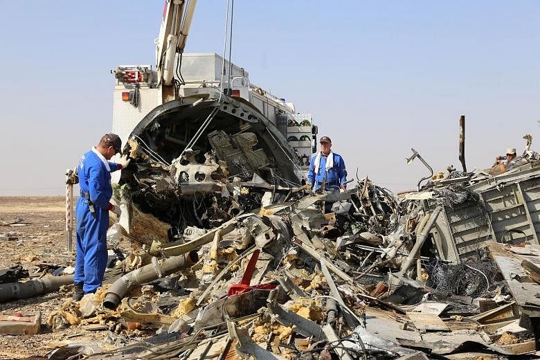 Russian emergency services personnel working at the plane's crash site in Wadi al-Zolomat, a mountainous area of Egypt's Sinai peninsula, in a handout picture from Russia's Emergency Ministry.