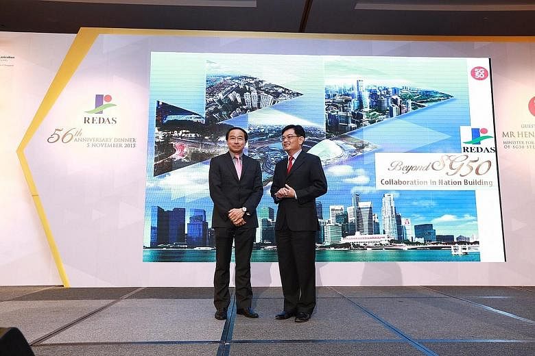 Redas president Augustine Tan (left) and Finance Minister Heng Swee Keat both outlined the challenges faced by the property industry at the association's 56th anniversary dinner at Marina Bay Sands last night.