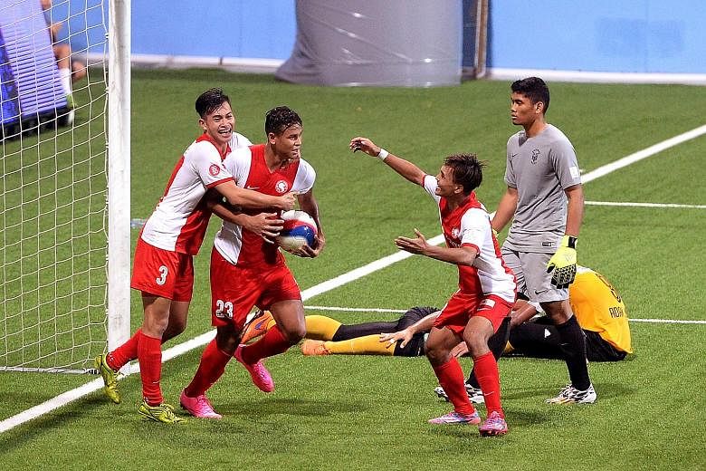 Taufik Suparno (right) celebrating with fellow striker Irfan Fandi after the latter's late equaliser against Harimau Muda last month. He won the Prime League with Tampines and has played five S-League games.