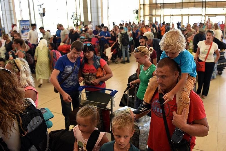 Deprting tourists waiting at the airport of Egypt's Red Sea resort of Sharm El-Sheikh yesterday. The resort was where a Russian plane took off last Saturday bound for St Petersburg before crashing minutes later, killing all on board.