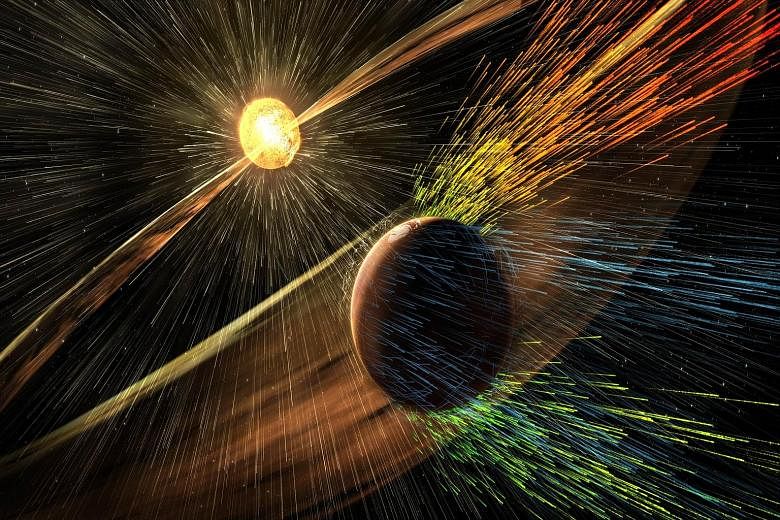 This Nasa image released on Thursday shows an artist's rendering of a solar storm hitting Mars and stripping ions from its upper atmosphere.