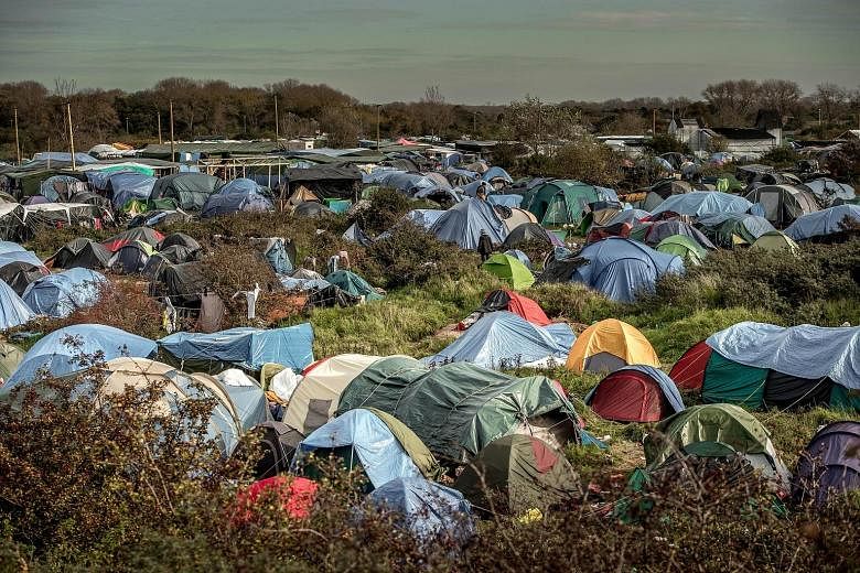 A migrant camp in Calais, France. In a forecast, EU officials predicted that the three million migrants expected over the next three years would provide a small net gain to the European economy by 2017.