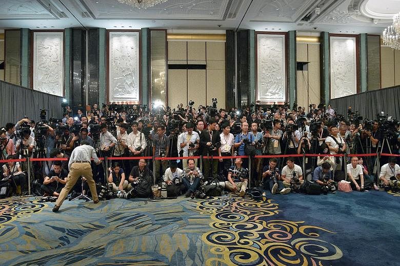 The media waiting in the ballroom during the meeting between Chinese President Xi Jinping and Taiwanese President Ma Ying-jeou yesterday. There was tension as the journalists jostled for a good spot and it took the low-key entrance of Mr Xi and Mr Ma
