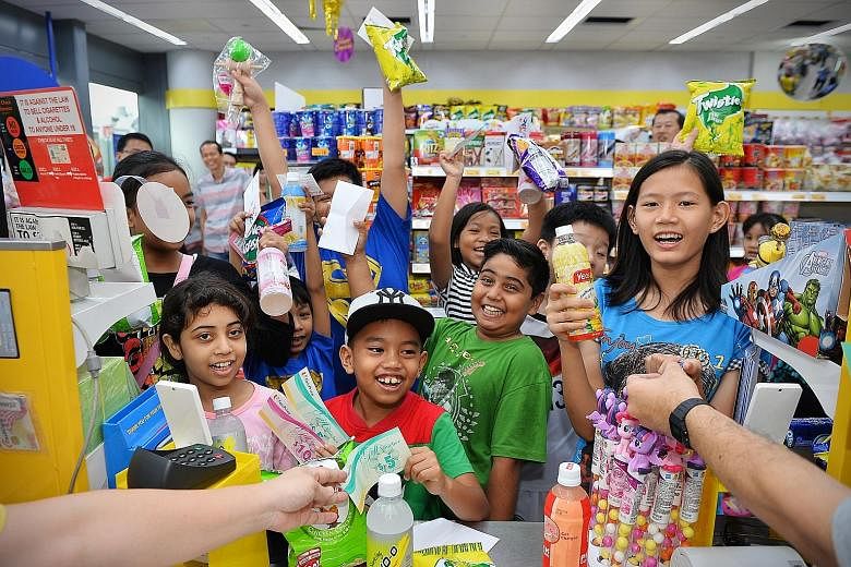 Twenty children helped by The Straits Times School Pocket Money Fund enjoyed a sponsored shopping trip to a Cheers outlet at Kallang Wave Mall yesterday, where they were given $15 each in vouchers to purchase food and drinks. The event marked the clo