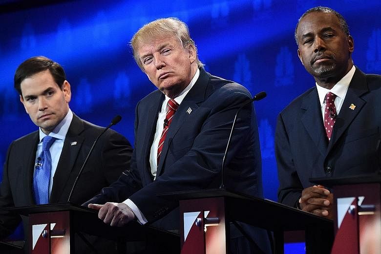 Presidential hopefuls (from left) Marco Rubio, Donald Trump and Ben Carson during the CNBC Republican Presidential Debate in Boulder last month. A poll of polls shows Dr Carson in the lead.