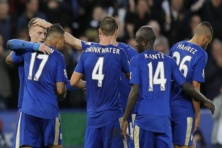 Leicester hotshot Jamie Vardy (left) being congratulated by team-mates after extending his scoring run to nine Premier League games.