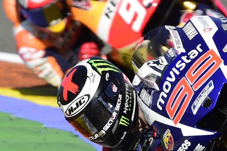Jorge Lorenzo in the lead with Marc Marquez on his tail yesterday. Valentino Rossi's fourth place in Valencia meant he ended five points behind Lorenzo in the championship with 325.