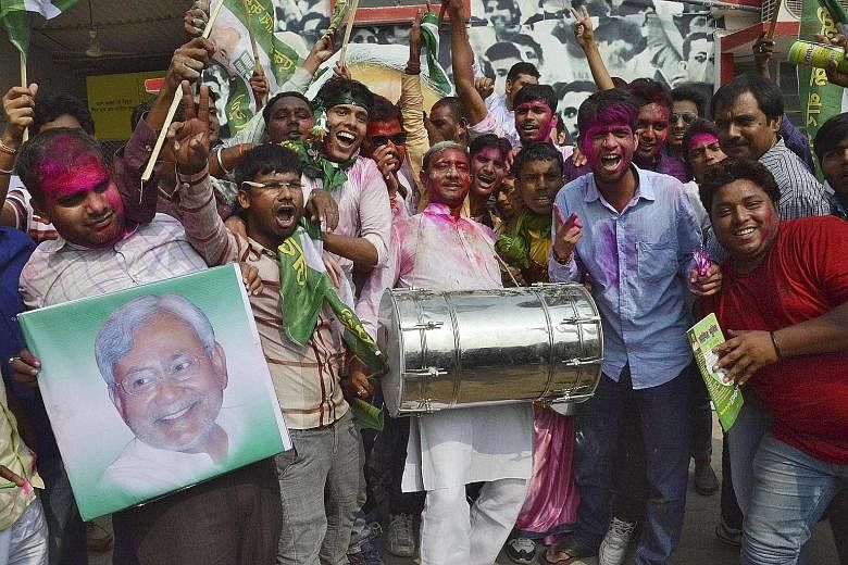 Janata Dal (United) party supporters celebrating after learning of the initial poll results at their party office in Patna, Bihar, yesterday. Mr Modi, who addressed over two dozen rallies in the state ahead of the polls, yesterday accepted defeat and
