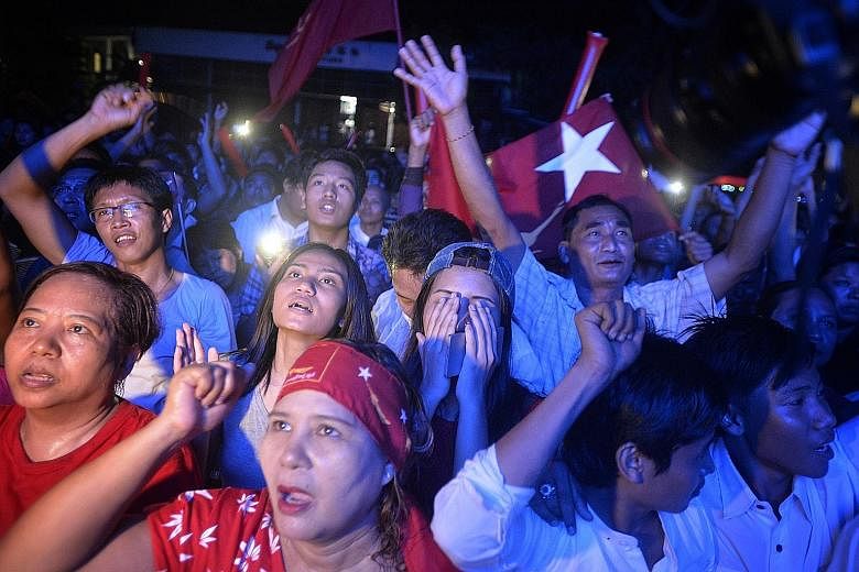 National League for Democracy supporters singing in anticipation of victory outside the party's headquarters in Yangon yesterday.