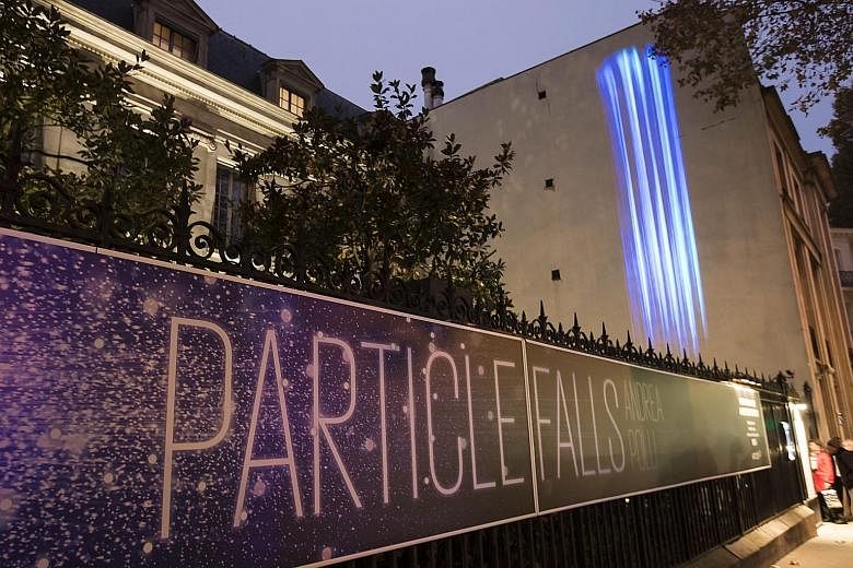 An art installation called "Particle Falls" by US environmental artist Andrea Polli projected on the Mon Bismarck American Centre in Paris, as part of an initiative to promote climate change issues.