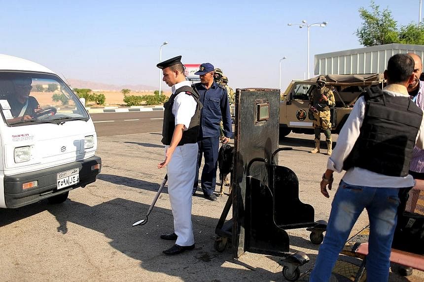 Police officers inspecting cars going into Sharm el-Sheikh airport last Saturday. The crash of a Russian jet has piled pressure on the airport.