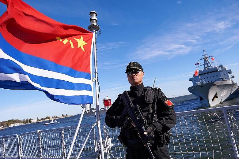 A crewman standing watch during a historic visit - the Chinese navy's first - to the port of Gdynia in Poland. All in, three Chinese ships docked in the Baltic sea port on Oct 7 for a five-day visit to mark the 66th anniversary of the establishment o