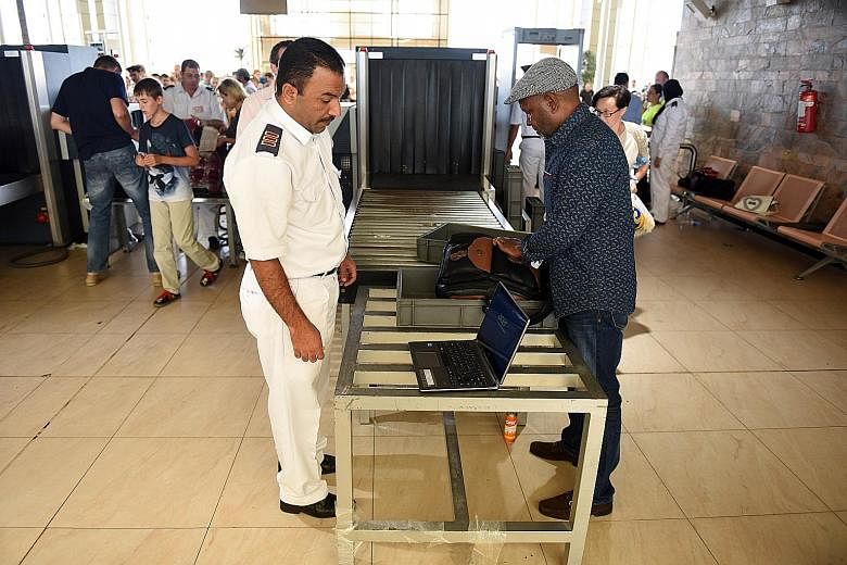 A passenger having his luggage checked at Sharm el-Sheikh airport in Egypt in the wake of the Oct 31 plane crash at the Red Sea resort.