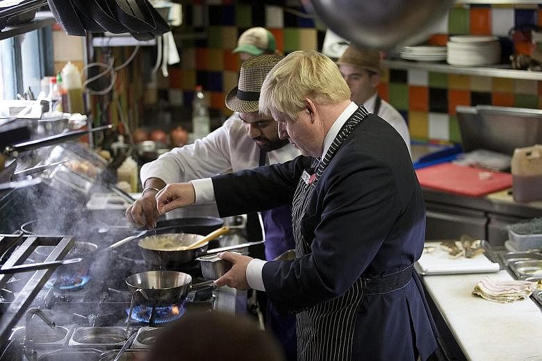 Mayor of London Boris Johnson (right) donned an apron and cooked with the help of Israeli chef Uri Navon while he was at Machneyuda restaurant in Mahane Yehuda Market in Jerusalem yesterday. Mr Johnson was on a three-day official trip to Israel and t