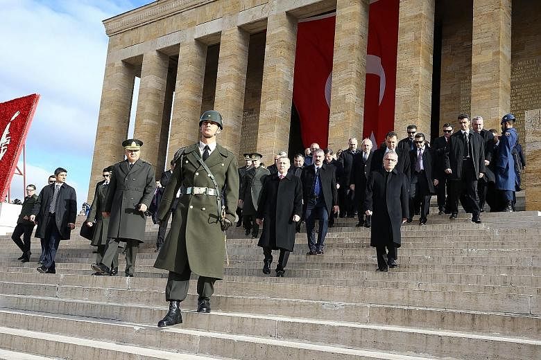 Turkish President Recep Tayyip Erdogan (centre) visiting the mausoleum of Mustafa Kemal Ataturk yesterday, the 77th death anniversary of modern Turkey's founding father.