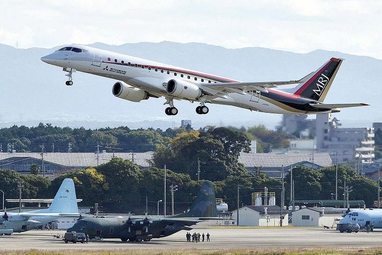 The Mitsubishi Regional Jet, painted with dark blue, red and beige stripes, took off from Nagoya airport under clear skies for a 90-minute test trip yesterday.