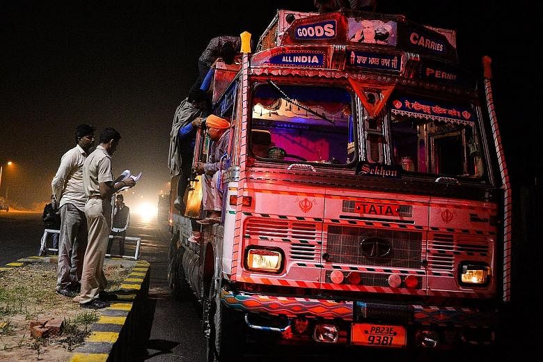 Members of the vigilante group Gau Raksha Dal inspecting a truck on a highway in Rajasthan.