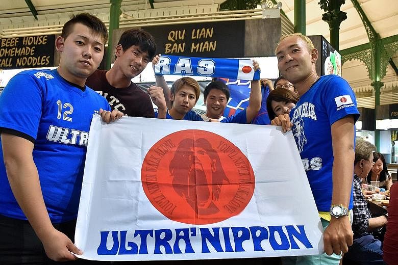 A group of Samurai Blue loyalists display the colours of Ultra Nippon, the committed group of fans who travel the world to support the Japanese national team.