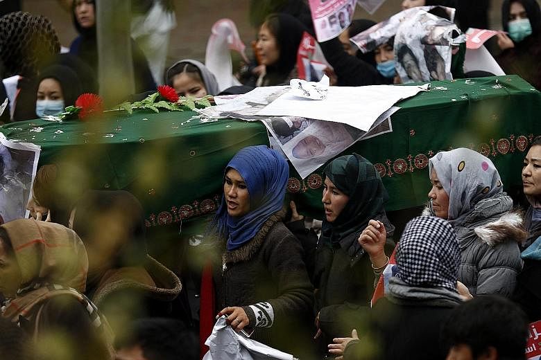 Protesters carrying the coffin of a slain Shi'ite Hazara in Kabul yesterday. The victims were believed to have been held hostage by gunmen for months. Their bodies were found last Saturday.