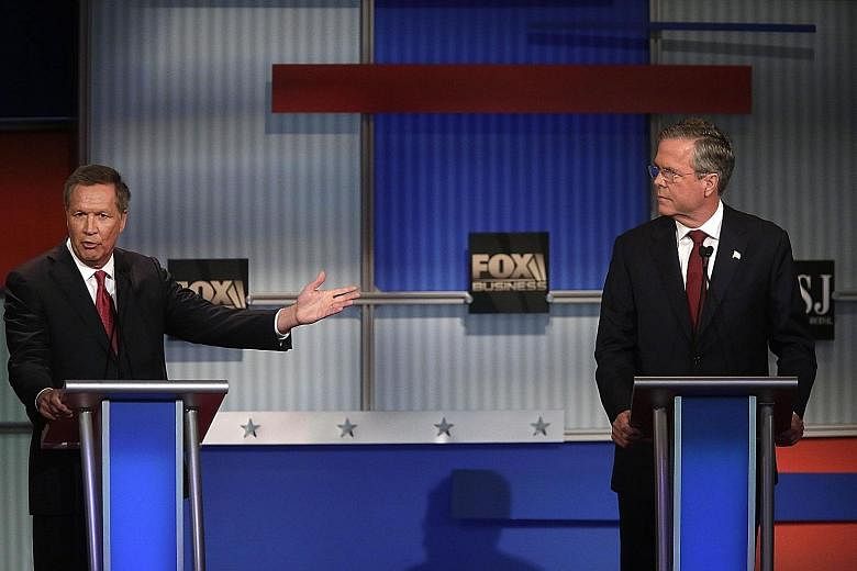 Republican presidential candidates Jeb Bush (right) and John R. Kasich at the Republican Presidential Debate on Tuesday in Milwaukee, Wisconsin. They presented themselves as experienced chief executives with practical solutions to deal with national 