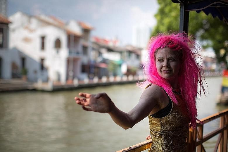 Australian artist Lisa Dethridge performing by the Malacca River at last year's festival, which drew over 35,000 people.