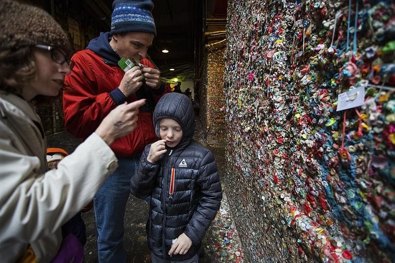 Mrs Christie Fergus, with her husband Brian and son Michael, visiting from Phoenix to contribute to the gum wall. In the days before the big clean-up, there was a rush of last-minute visits and gum-themed selfies.