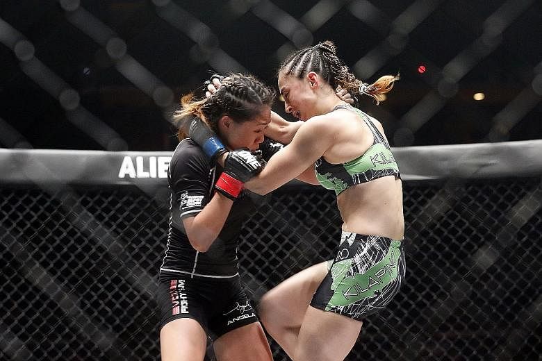 Born in Canada and raised in Hawaii, strawweight Angela Lee (in black) won her third straight fight by submission. She beat Australian Natalie Hills and then said the support she received from the crowd reminded her why it's so special to fight for S