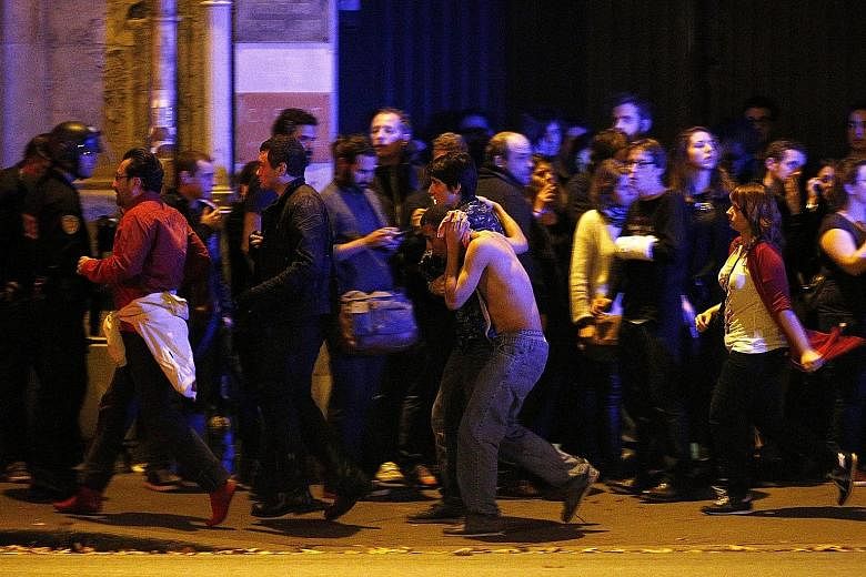 Wounded people being taken out of the Bataclan theatre in Paris following the shootings and hostage situation that took place on Friday night. French President Francois Hollande said yesterday that the attacks in the city, which killed at least 128 p