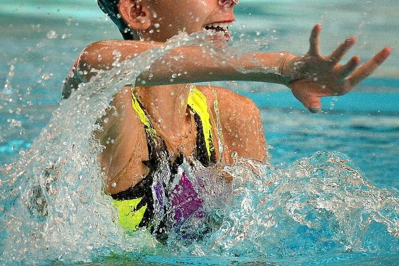 Debbie Soh (left, with 71.9234 points) and Carolyn Buckle (69.2926) of the Singapore Swimming Association finishing first and second in the Open solo technical routine at the 10th Singapore National Synchronised Swimming Championships yesterday. The 