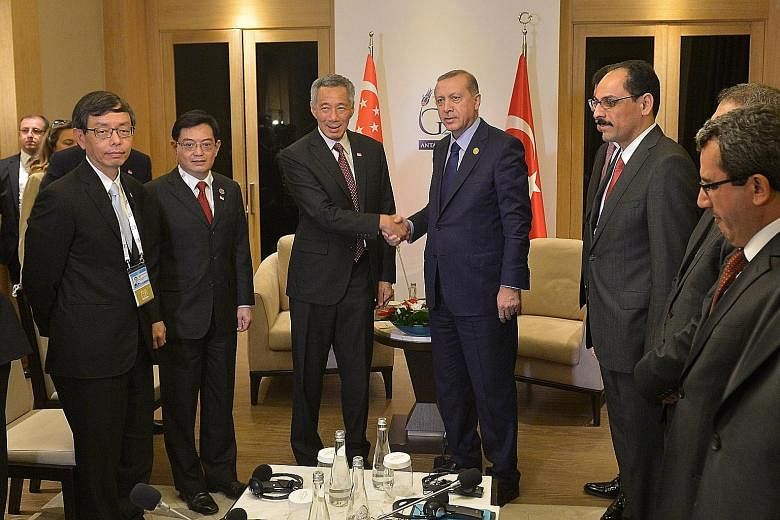Prime Minister Lee Hsien Loong meeting Turkish President Recep Tayyip Erdogan in Antalya yesterday. With them are (from left) Civil Service head Peter Ong, Finance Minister Heng Swee Keat and Turkey's presidential spokesman Ibrahim Kalin (right).