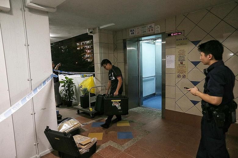 Police at the Bedok North block of flats where the murder occurred last Friday.