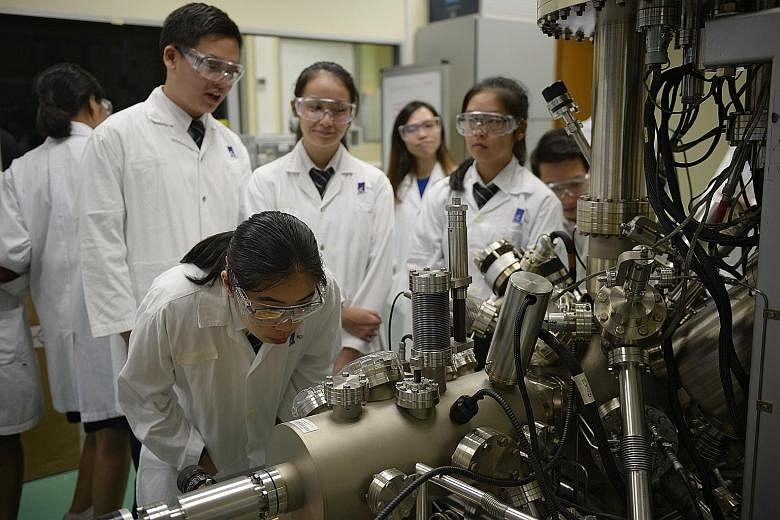 St Andrew's Junior College students observing X-ray Photoelectron Spectroscopy at the Central Lab during a visit to the Institute of Chemical and Engineering Sciences on Thursday.