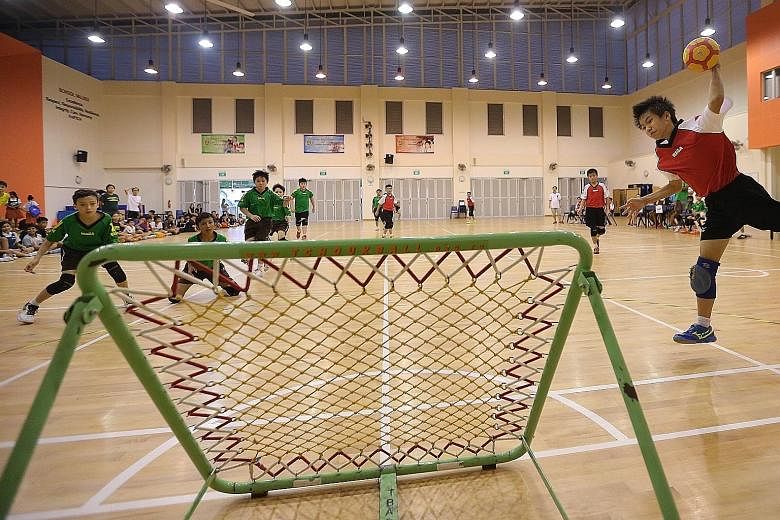 Greendale Primary's tchoukball captain Xavier Kew (extreme right), 11, about to score against St Anthony's Primary during the boys' final of the SPH Foundation National Primary Schools Tchoukball Championships held at Junyuan Primary School yesterday
