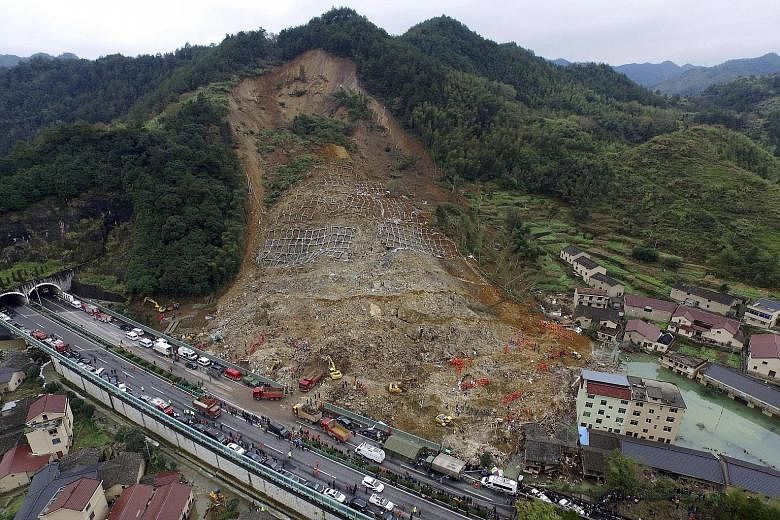 An aerial view of rescuers searching for survivors at the site of a landslide in China's Zhejiang province. Only one person has been rescued so far in the disaster which struck last Friday. The death toll stands at 25, with 12 people missing.