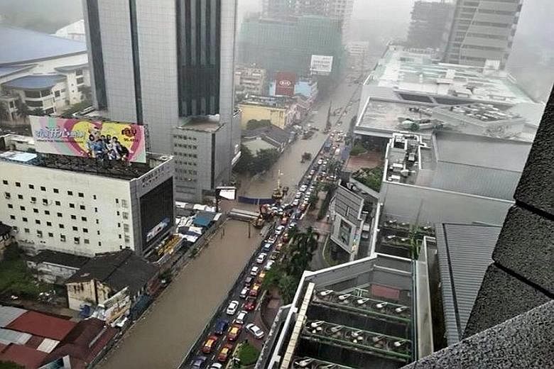 The two-hour downpour left traffic at a standstill at all major roads leading into the city, while many basement carparks in the city centre were also flooded.