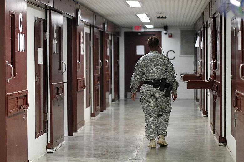 A guard at the US Guantanamo Bay prison camp. The Obama administration is expected to send Congress a plan soon to close the Guantanamo prison, including moving 59 detainees, who are not recommended for transfer, to a US jail.