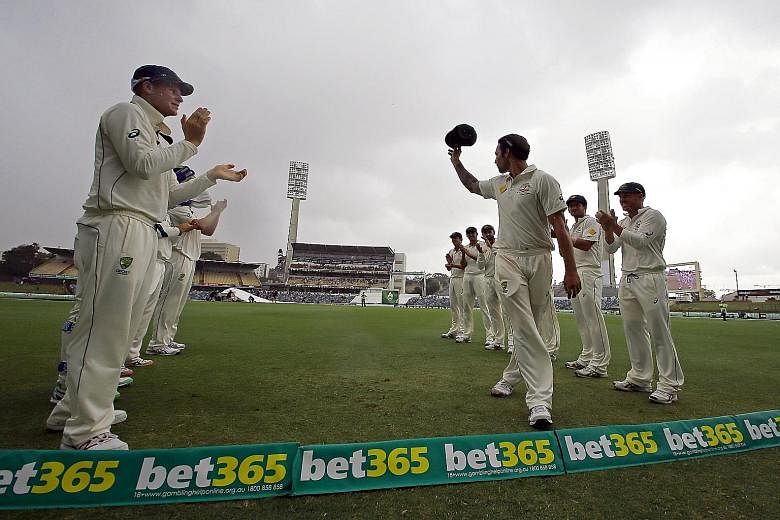 Australia's Mitchell Johnson being applauded off the field by his team-mates during the final day of the second Test against New Zealand in Perth.