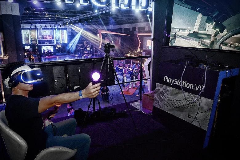 Student Andy Tan Khan Soon, 23, playing The London Heist Getaway at GameStart last Friday. He was one of 20 ST readers who got to try Sony's PlayStation VR, one of the biggest draws at the event and part of the first wave of virtual reality devices s