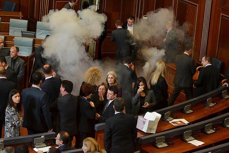 Kosovo MPs in Parliament yesterday when opposition lawmakers protesting against deals with Serbia fired tear gas and pepper spray.