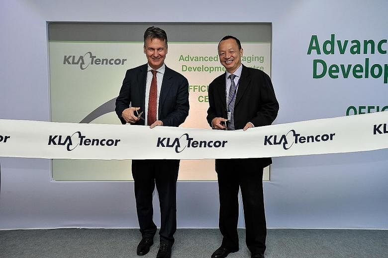 At the opening yesterday are Mr Bobby Bell (left), executive vice-president of KLA-Tencor's Wafer Inspection Group, and Mr Chang Chin Nam, executive director of precision engineering at the Singapore Economic Development Board.