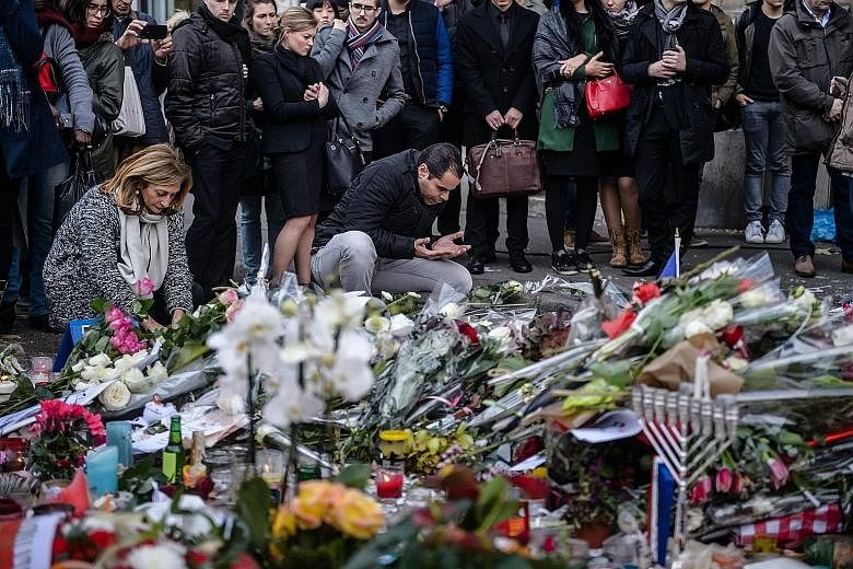 A Muslim man praying on Monday at a memorial site near the Bataclan concert hall, where most of the carnage occurred during last Friday's terror attacks in Paris. French Muslims have been included in the sense of unity in the wake of the attacks, wit